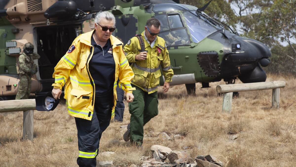 ACT Emergency Services Agency Commissioner Georgeina Whelan and ACT Parks and Conservation Manager Brett McNamara disembark from an MRH-90 Taipan helicopter at Mt Ginini. Picture: Department of Defence