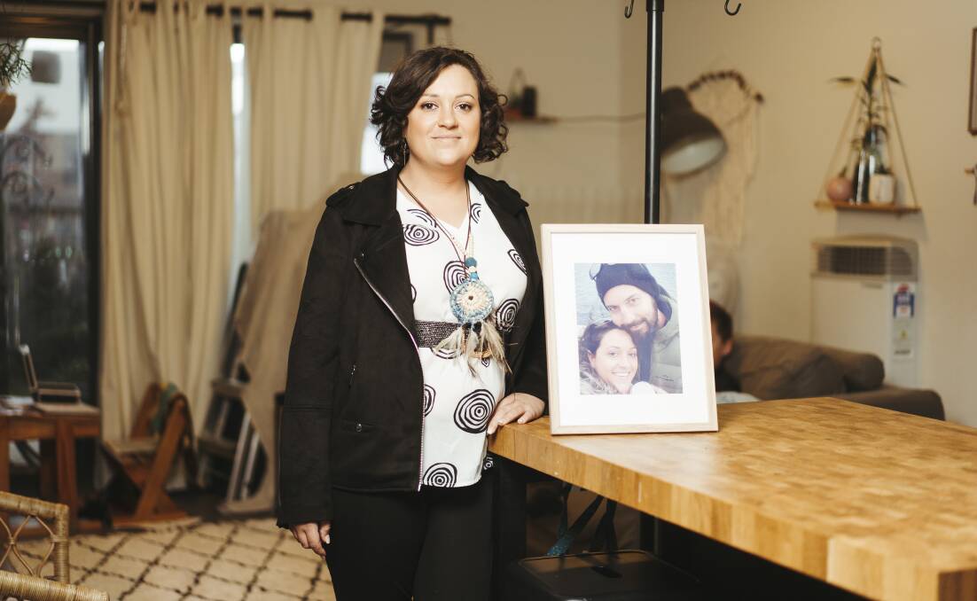 Canberra woman Bryony Lowe with a framed photo of her partner, Ben Sharp, who died at only 42 years of age after losing his battle with lung cancer. Picture: Dion Georgopoulos