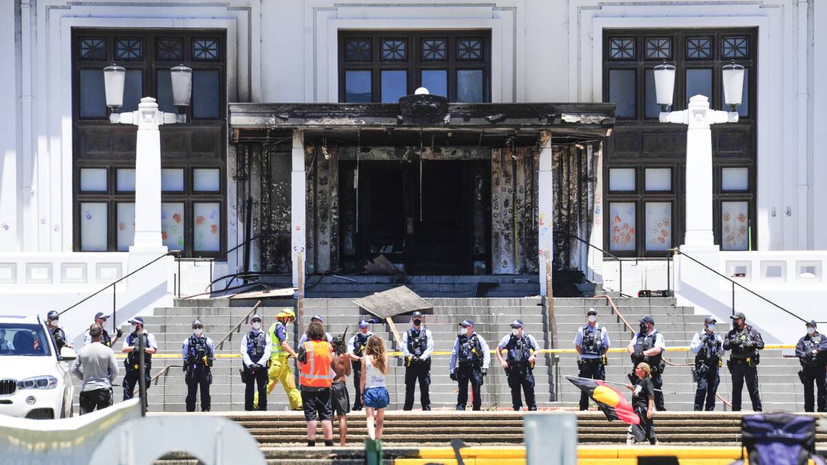 Police watch over Old Parliament House following the aftermath of the fire in December. Picture: Dion Georgopoulos.