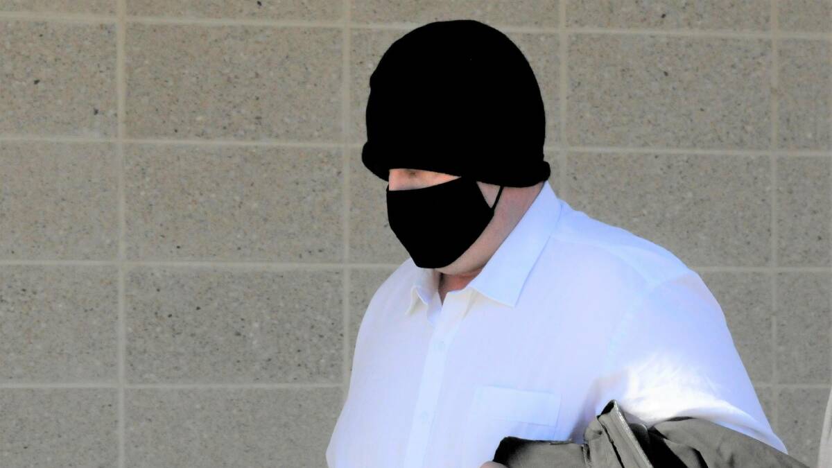 Scott Whittaker disguises himself with a beanie and face mask outside court after a previous appearance. Picture: Blake Foden