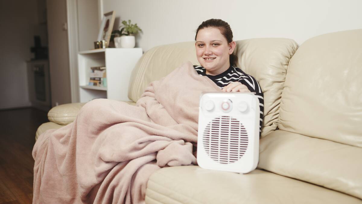 Canberra resident Elizabeth Veasey at her apartment in Wright, who stays true to the Canberra Anzac Day heater rules and finds other ways to stay warm before April 25. Picture: Dion Georgopoulos