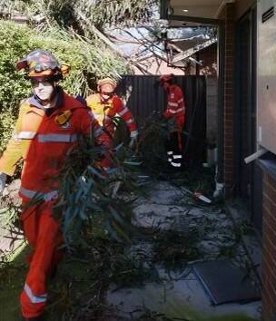 ACT SES crew members clear the debris in Mawson. Picture: ACT ESA