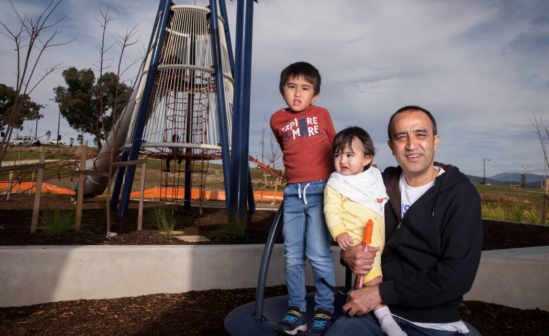 Future Whitlam resident Muhammad Idrees with his children Ali Hasan, 5, and Mehar Hasan, 13 months, at the Mingle event on Saturday. Picture: Sitthixay Ditthavong