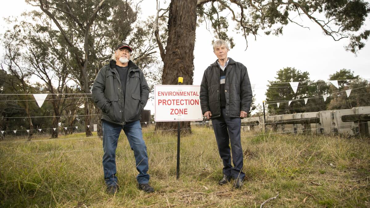 Ngunnawal Elder Wally Bell and Ginninderra Catchment Group's John Connelly next to one of the cultural ring trees on the Barton Highway. Picture: Keegan Carroll