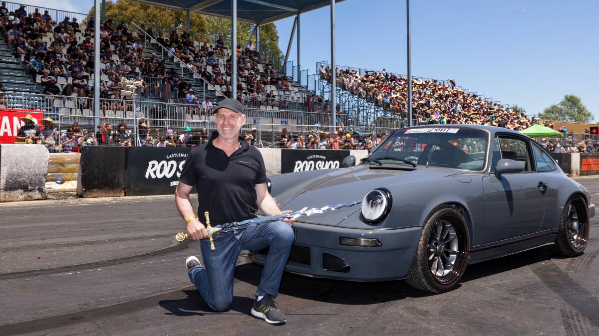 Michelago's Livi Krevatin receives the Chic Henry grand master sword after being announced as Summernats 35 grand champion with his Porsche 911. Picture by Sitthixay Ditthavong