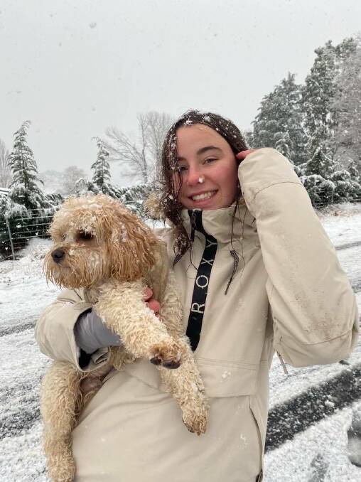 Youth Olympic Games gold medallist Josie Baff enjoying the snow with her dog, Alvin. Picture: Supplied