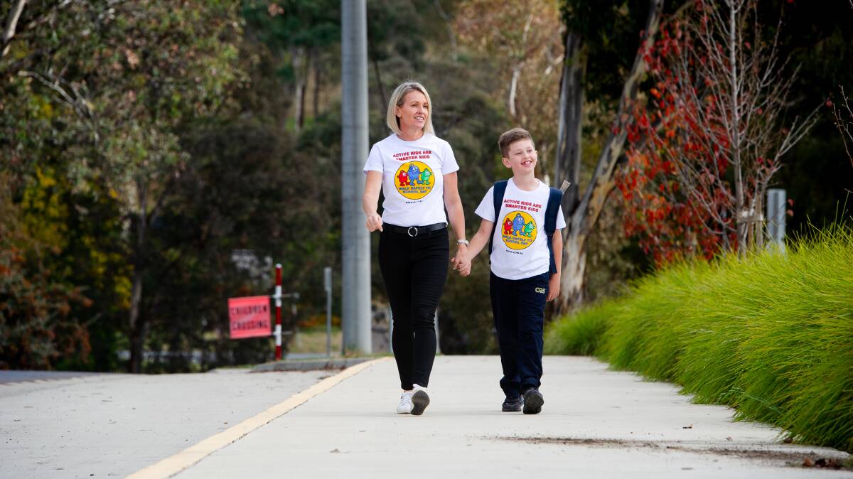 National Walk Safely to School day ambassador, former Olympian Louise Dobson, with her son Max Milin. Picture: Elesa Kurtz