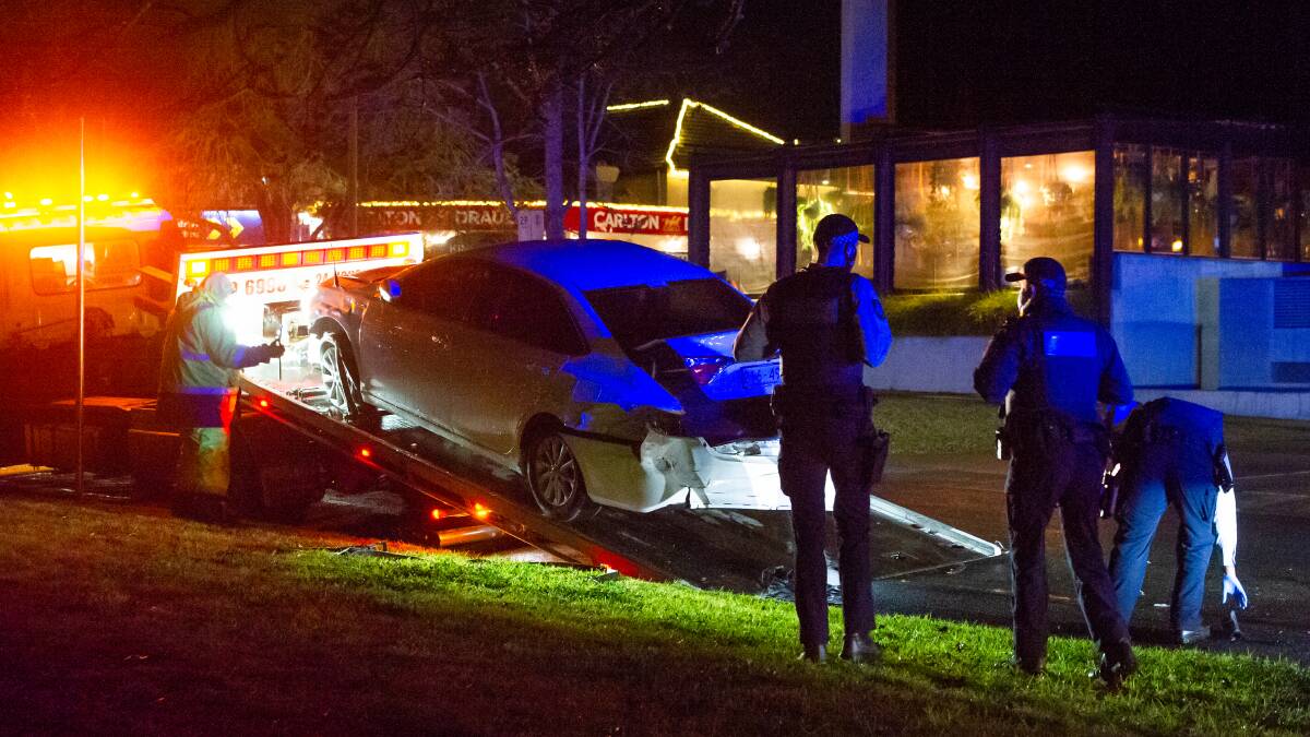 Police observe the smashed-up transport car in Griffith. Picture: Karleen Minney