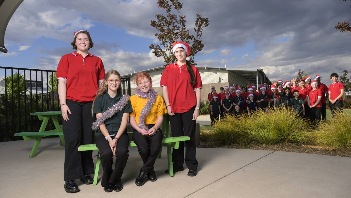 Woden Valley Youth Choir members Evangeline Osborne, 18, Lily-Anne Lancaster, 11, Heloise Moffat, 10 and Gwendolyn Osborne, 13, prepare for their final rehearsal for the Carols by Candlelight 2023. Picture by Keegan Carroll