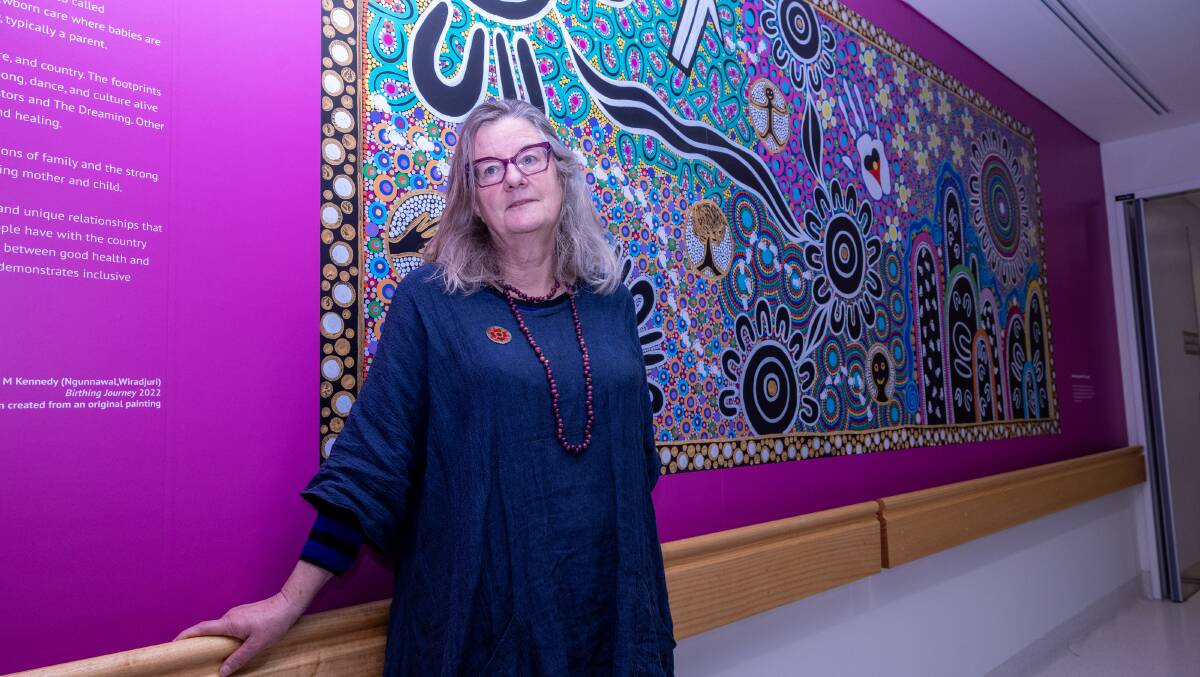 Dr Jenny McFarlane, curator of arts in health at Canberra Heart Services, with a piece by Latoya Kennedy. Picture by Gary Rampage