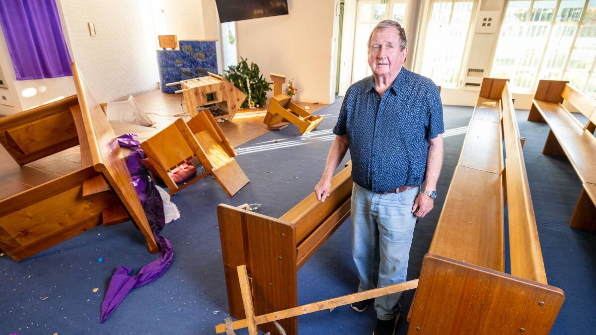 Parishioner Bill Fitzpatrick surveys the damage to St Thomas Aquinas church in Charnwood. Picture: Sitthixay Ditthavong