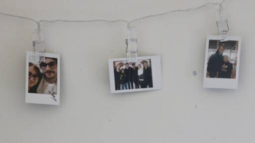 Polaroids hung up in Julie's bedroom. From left: Julie and Michael Clifford; Julie and the entire band; Julie and Luke Hemmings. Picture: Lanie Tindale