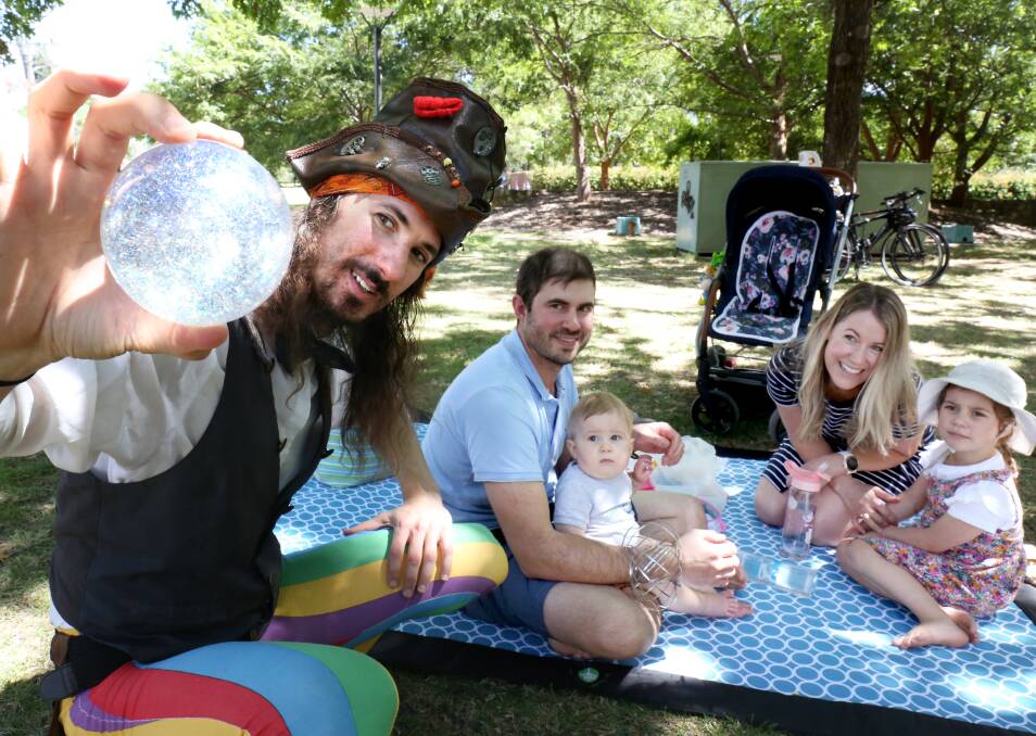 Pirate man Michael performs as (left to right) Evan Triaca, Charlie Fallon, 11 months, Nina Triaca, 4, and Naomi Fallon look on. Picture: James Croucher
