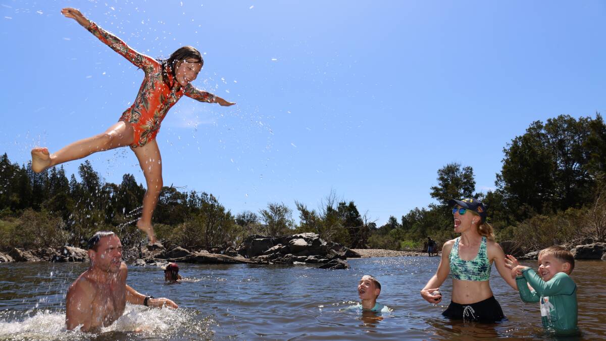 Ben and Miriam Witteveen from Hackett with their children Charlotte, 9, Zac, 12, and Sam, 5, swimming in the Murrumbidgee river at Pine Island Reserve. Picture by James Croucher