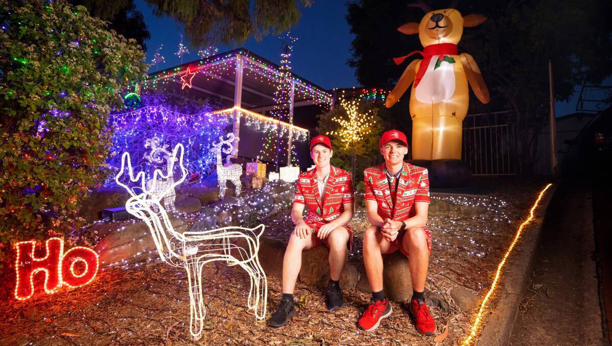 James Crowther and Ben Walker raise funds for MS with their Christmas light displays. Picture: Sitthixay Ditthavong