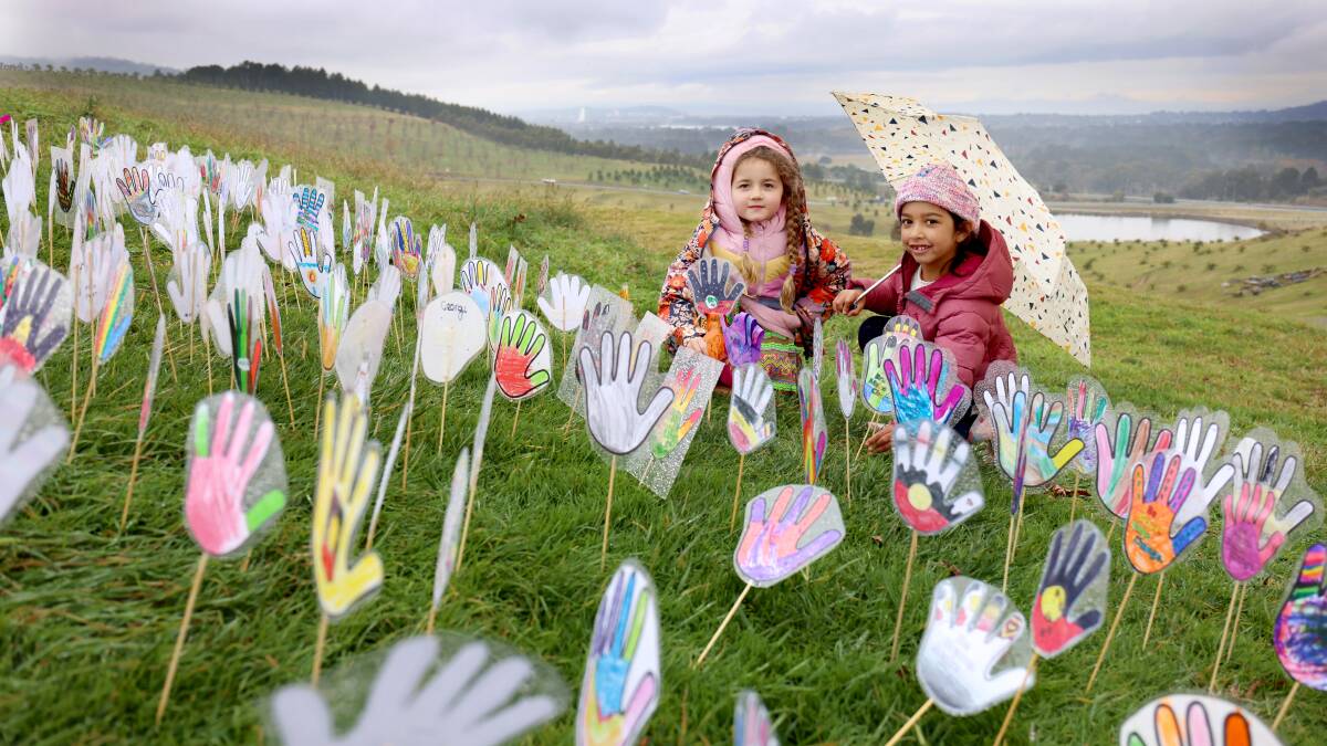 Tildie, 6, and Aliya, 6, from Lyneham Primary school at the fifth annual Reconciliation Day held at the National Arboretum in Canberra. Picture: James Croucher