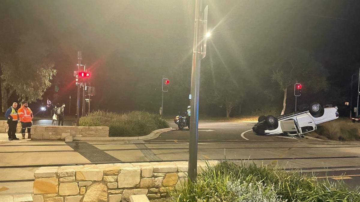 A ute rolled after colliding with a tram on Northbourne Avenue. Picture: Scott Hannaford