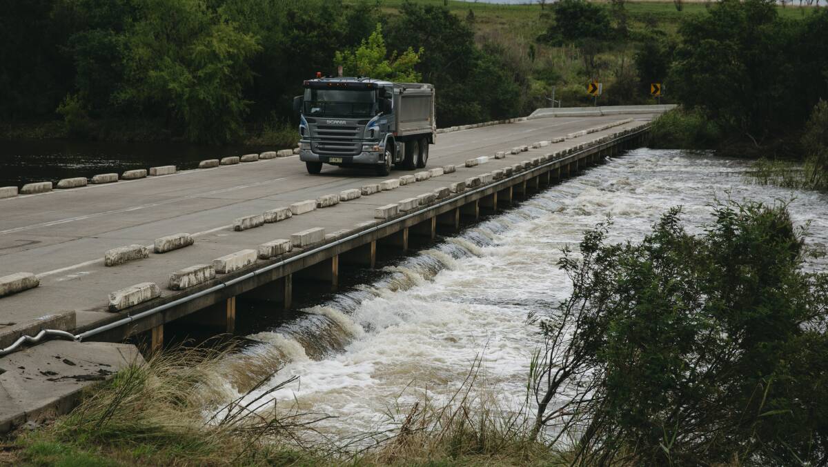 Heavy water flows at Point Hut crossing after rainfall in Canberra this week. Picture: Dion Georgopoulos