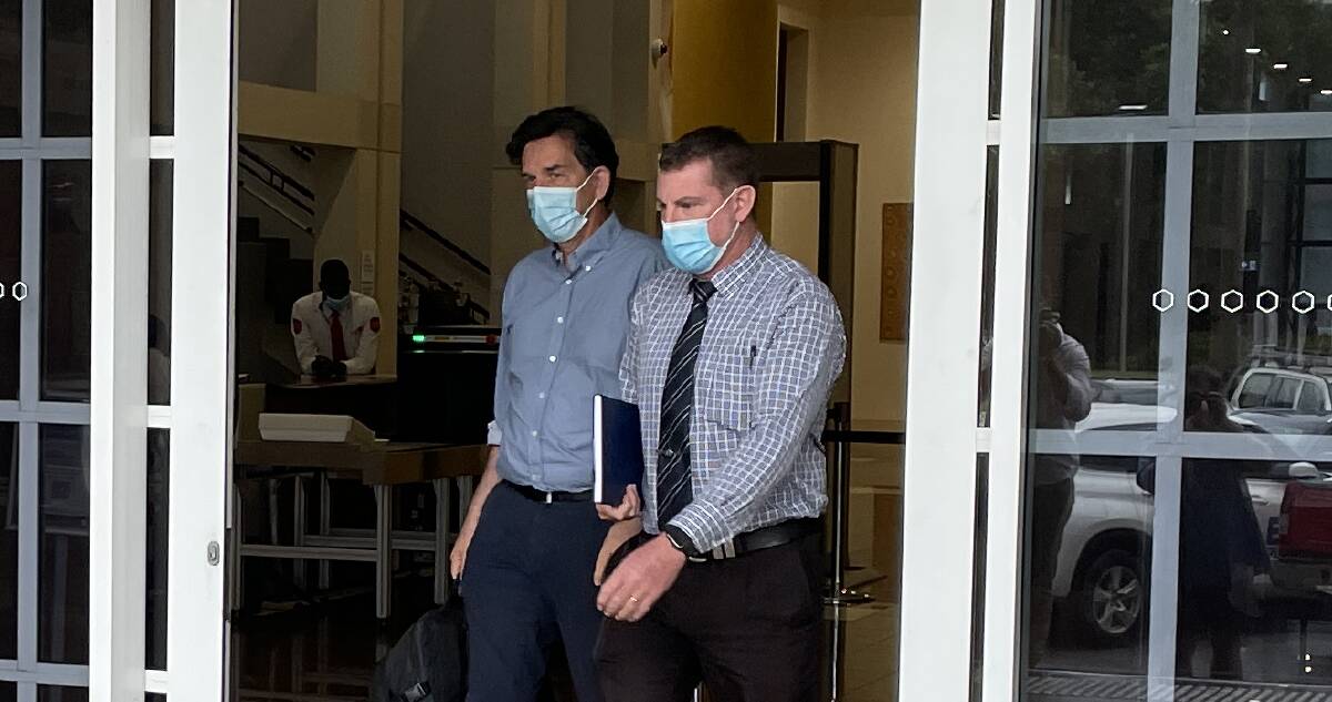 Biomechanics expert Dr Andrew McIntosh (left) leaves the Darwin Supreme Court. Picture: Sarah Matthews
