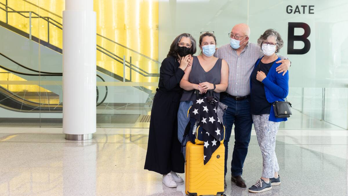 Claire Meeks, second from left, reunites with her sister Jane Cassidy, and parents John and Colette Mackay at Canberra Airport. Picture: Sitthixay Ditthavong