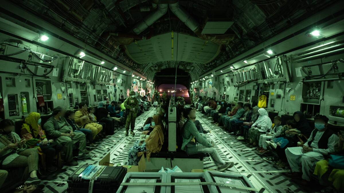 Australian citizens and visa holders are made comfortable by ADF personnel as they board the Royal Australian Air Force C-17A Globemaster preparing to depart Hamid Karzai International Airport. Picture: SGT Glen McCarthy (Australian Defence Force)