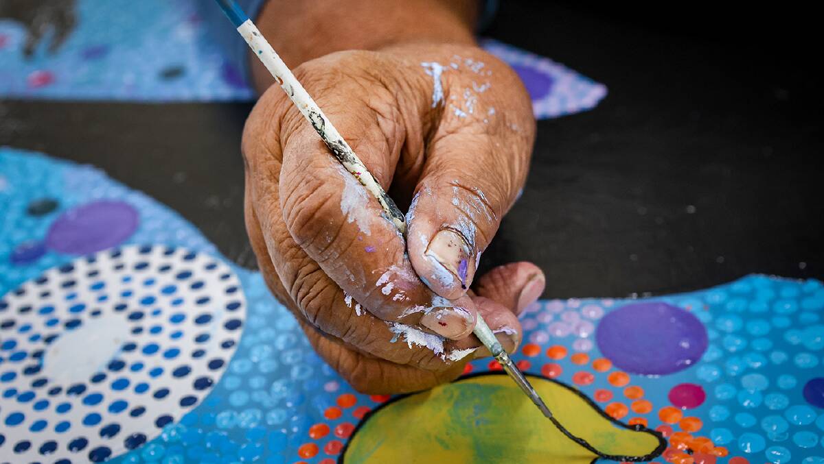 Aunty Lorraine Brown paints in the colours of the east coast saltwater people. Picture by Adam McLean