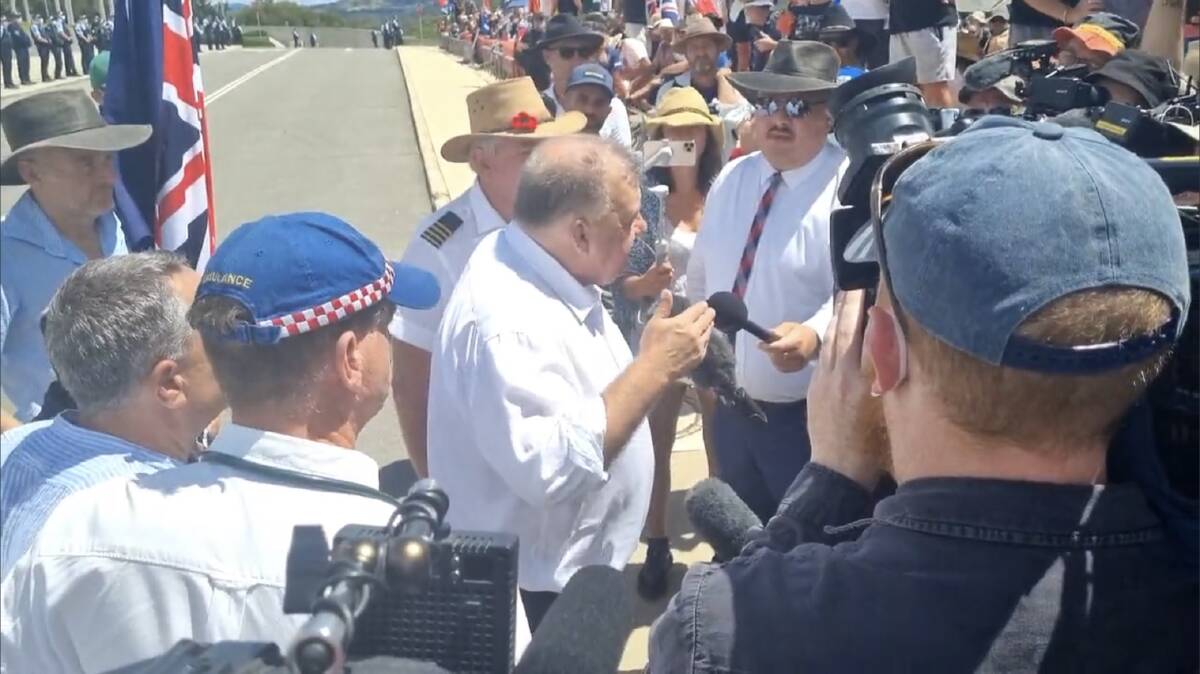 Simeon Boikov (right, in white shirt and tie) as Craig Kelly addresses protesters. Picture: Supplied