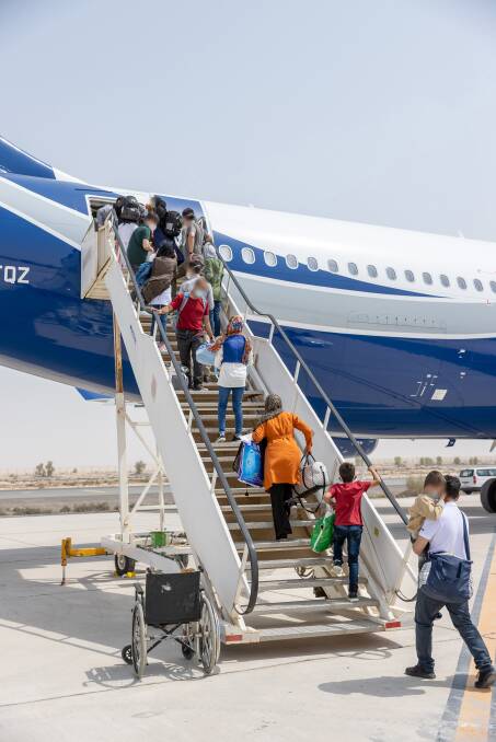 Evacuees at Australia's main operating base in the Middle East board a contracted aircraft heading for Australia after their evacuation from Kabul. Picture: Defence