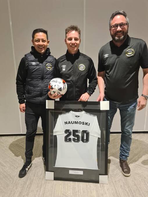 Misko Naumoski receiving his framed 250th game jersey with Gungahlin NPL coach Marcial Munoz (left) and club president Neil Harlock (right). Picture: Gungahlin United Facebook