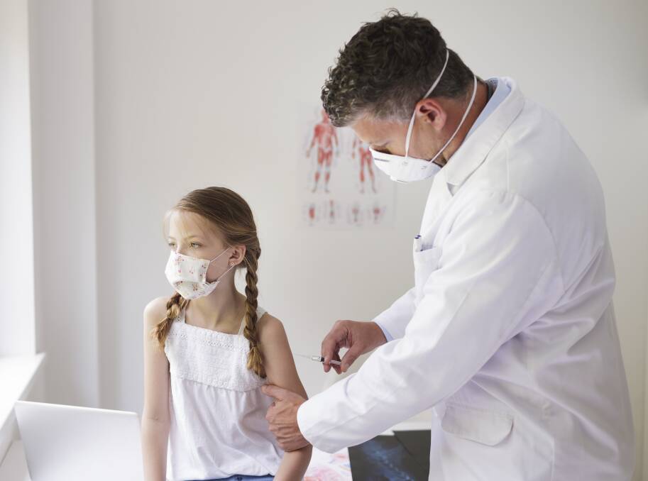 A doctor vaccinates a child. Parents are reportedly receiving "conflicting information" about whether vaccines are safe for children. Photo: Getty Images.