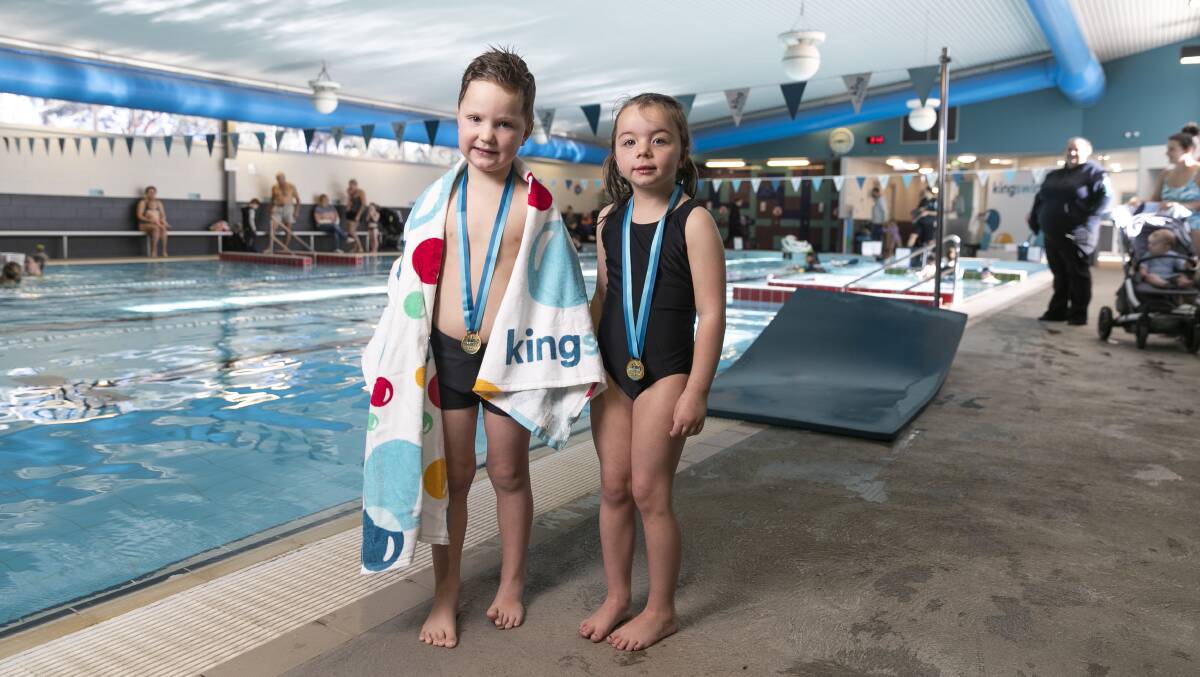 Macgregor Kingswim students Max Gunn and Emily Marks, both four years old, won their own medals this week. Picture: Keegan Carroll