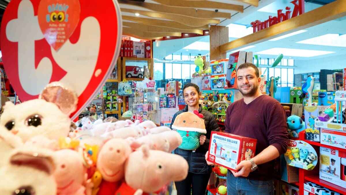Kidstuff sales assistant Vaibhavi Patel and store manager Amir Mortazavi preparing the Belconnen store for Boxing Day. Picture by Sitthixay Ditthavong