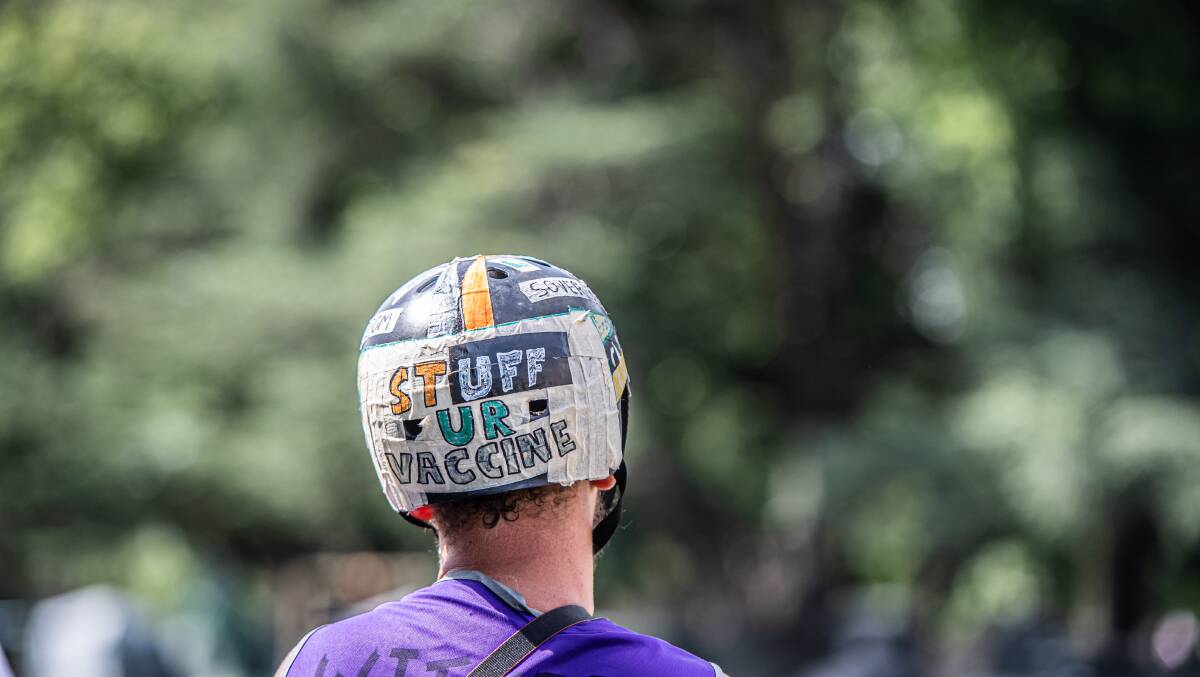 An anti-vaccination slogan on the back of a protester's bike helmet. Picture: Karleen Minney