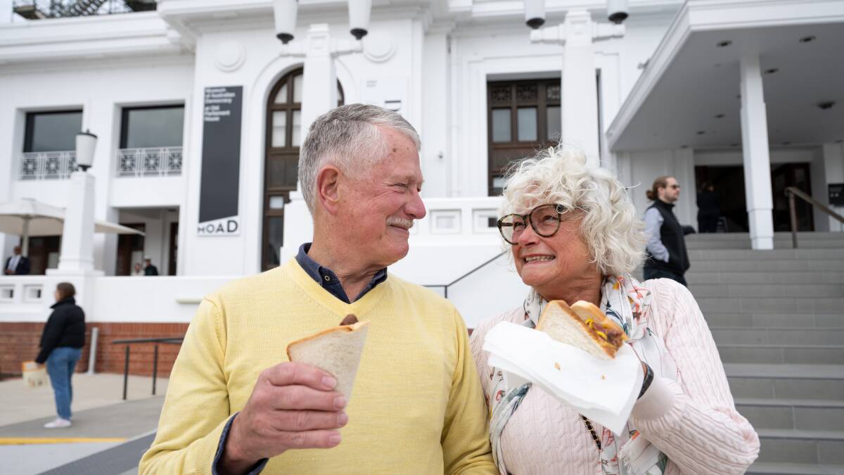 Fred and Judith Barnes of Watson, enjoy their democracy sausages at Old Parliament House on The Voice Referendum Day. Picture by Elesa Kurtz
