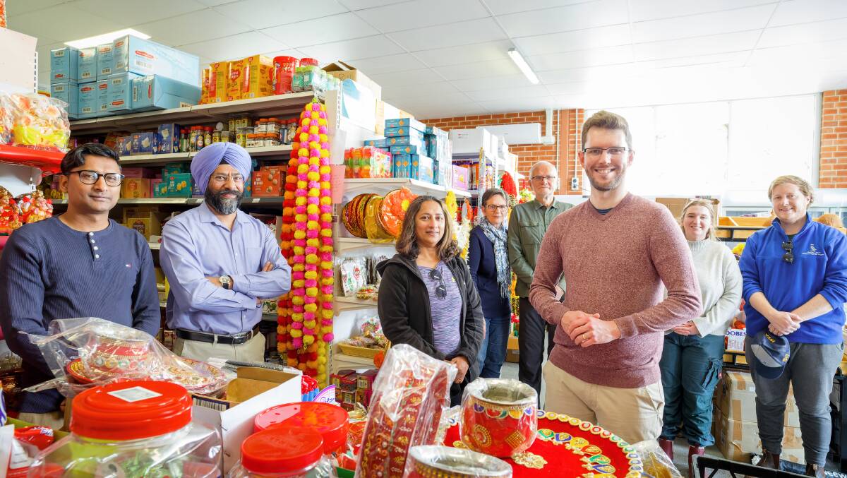 Raju Adhikari, Amardeep Singh, Sara Chandra, Alison and John Hutchison, Ryan Hemsley, and Elyssa and Dylan Castles visit Ajijo grocery store at Coombs shopping centre. Picture by Sitthixay Ditthavong