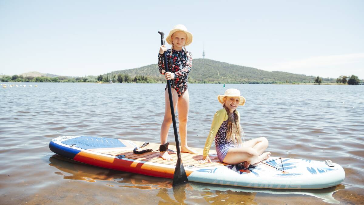 Aliana Ridgewell, 9, and Adeline Hubbard, 9 paddleboarding at Lake Burley Griffin on Saturday. Picture: Dion Georgopoulos