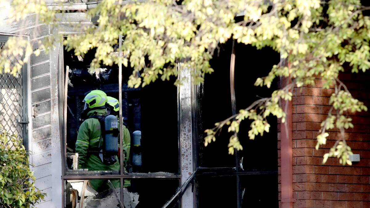 Firefighters after extinguishing a house fire in Tipping Place, McKellar. Picture: James Croucher
