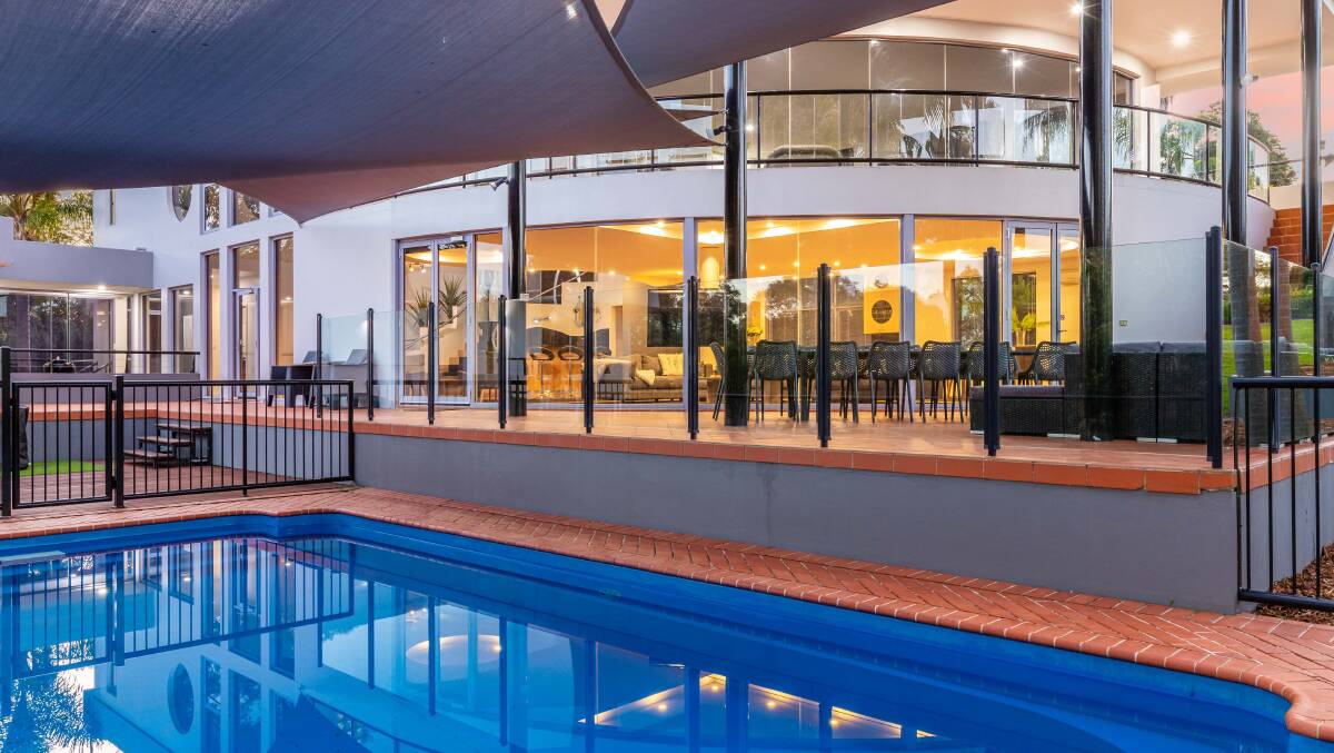 The three-level home is built for entertaining with a bar, cellar, outdoor deck area and swimming pool. Pictures: Ray White Batemans Bay