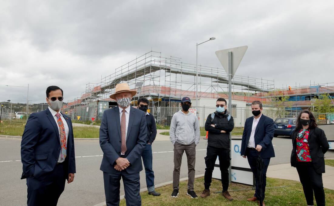 Lawyer Rahul Bedi, Canberra Liberals' Peter Cain and off-the-plan buyers Mohammad Choudhury, Wasantha Davidlage, Song Le, Reece Peart and Sheridan Burnett pictured in October at the Coombs site where developer 3 Property Group cancelled contracts. Picture: Sitthixay Ditthavong