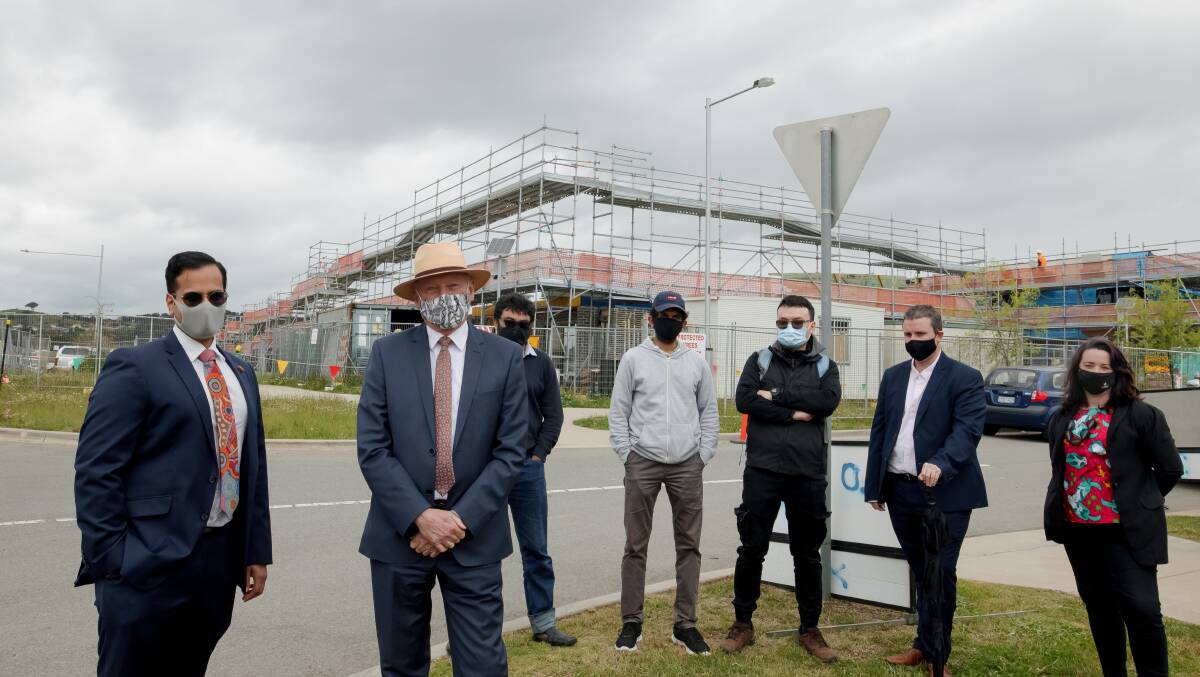 Lawyer Rahul Bedi, Canberra Liberals' Peter Cain and off-the-plan buyers Mohammad Choudhury, Wasantha Davidlage, Song Le, Reece Peart and Sheridan Burnett at the Coombs site where developer 3 Property Group cancelled contracts. Picture: Sitthixay Ditthavong