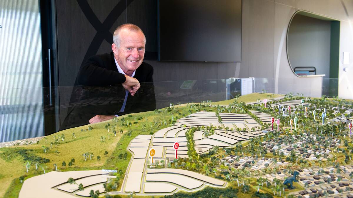 Googong project director Malcolm Leslie with a model of the township, which will eventually be home to 18,000 residents. Picture by Elesa Kurtz