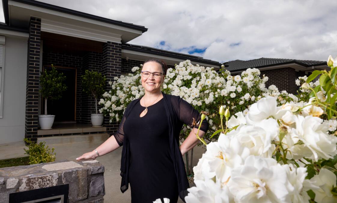 Upside Realty's Catherine Halloran stands outside 16 Munjuwa Street in Ngunnawal, a suburb she thinks will be highly sought after by home buyers in 2022. Picture: Sitthixay Ditthavong