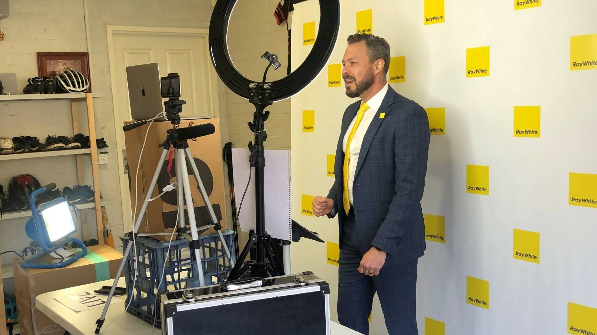 Ray White Canberra sales director and auctioneer Alec Brown conducts a virtual auction from his garage. Picture: Supplied