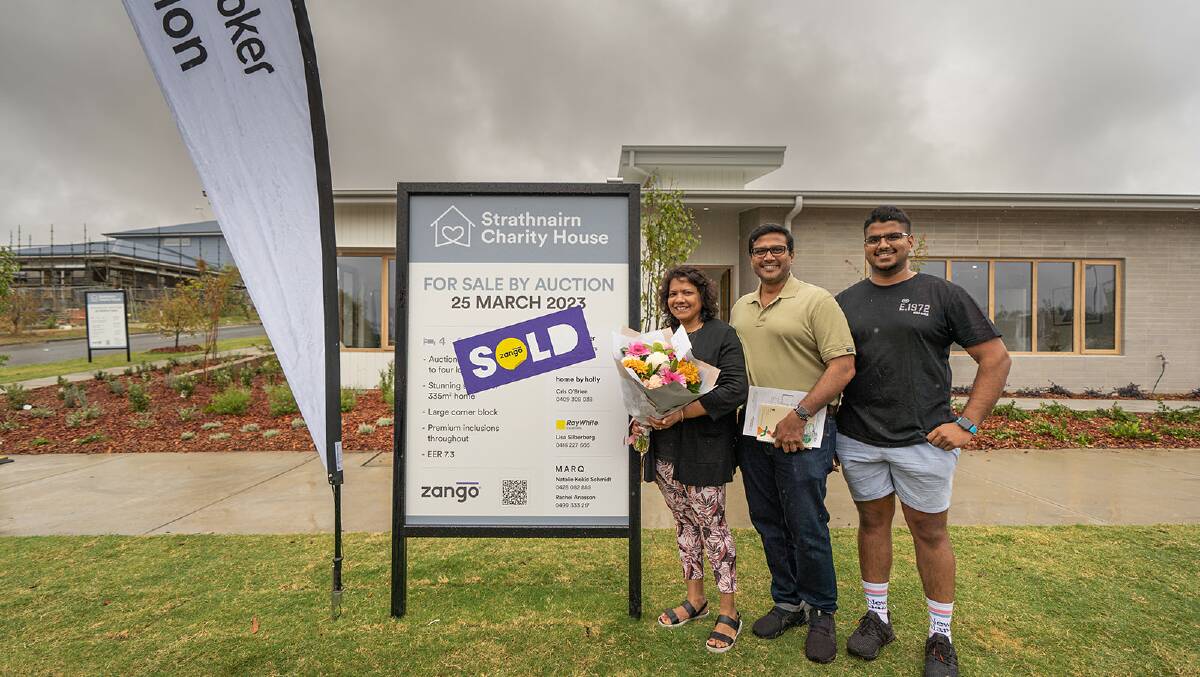 Buyers of the Strathnairn charity house Chamari and Naresh Gunasekere pictured with their son following the auction. Picture Dan Cusack Photography