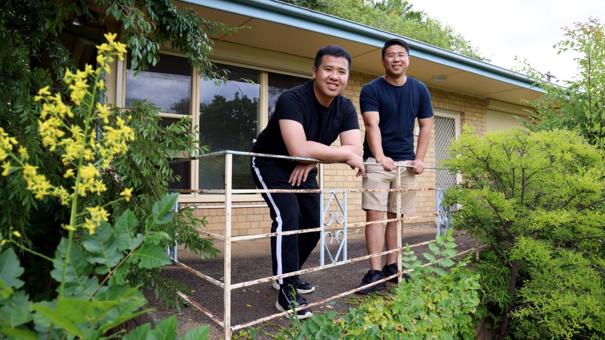 Business partners John Lin and Rulin Chang outside their Griffith investment property. Picture by James Croucher