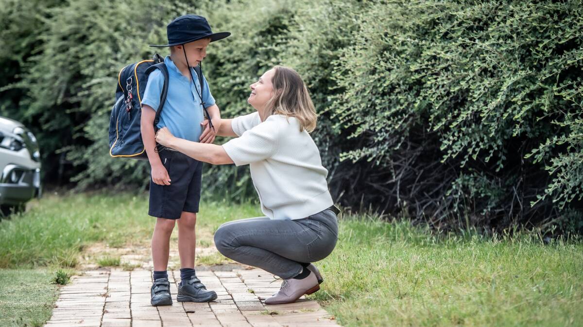 Back to school, first day of 2022 for kids attending St Bede's primary school in Red Hill. Cecile Wake tucks in 7 year old son Hugo Wake before his first day of year 2. Picture: Karleen Minney