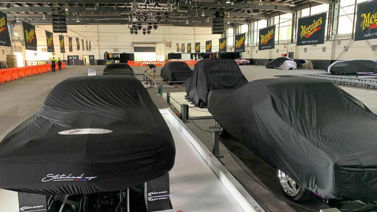 Elite cars hidden by covers until Friday night. Picture: Peter Brewer