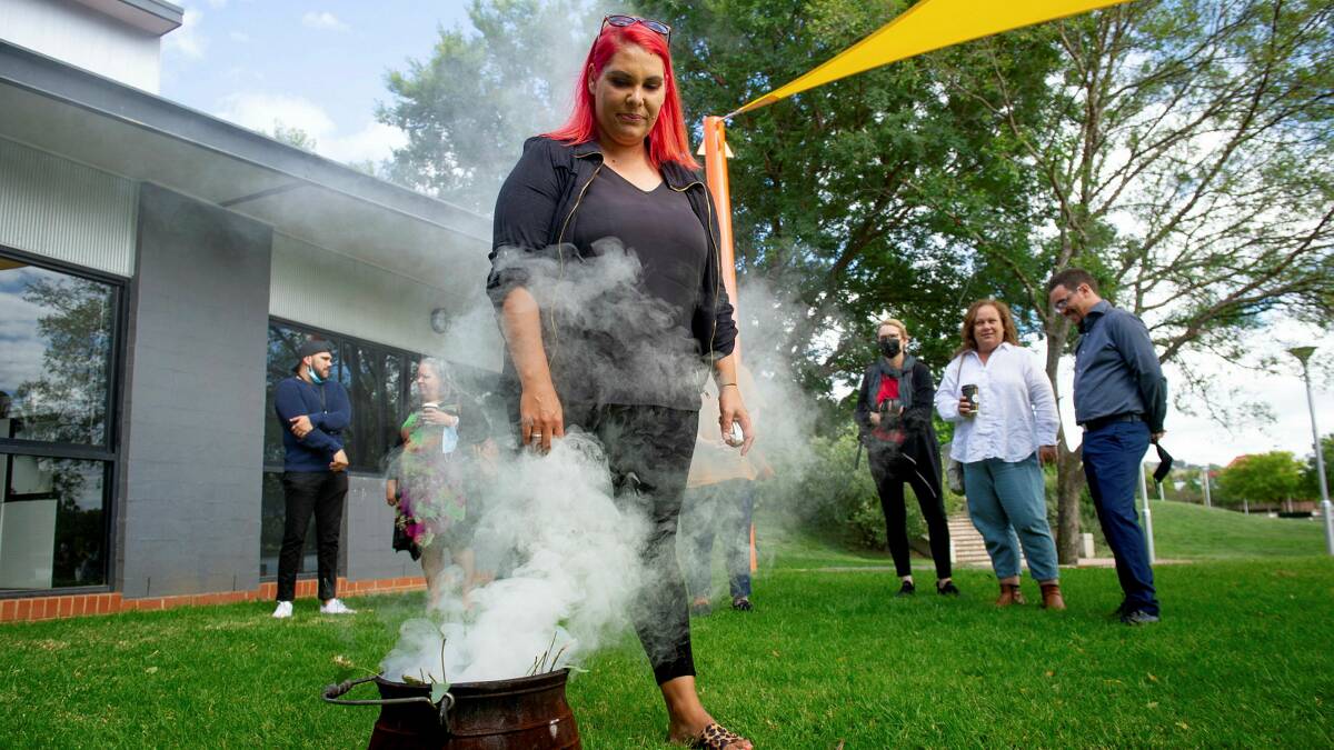 Gulanga program manager Rachelle Kelly-Church is cleansed in the smoking ceremony at the 14th anniversary of national apology to stolen generations at Tuggeranong Arts Centre. Picture: Elesa Kurtz