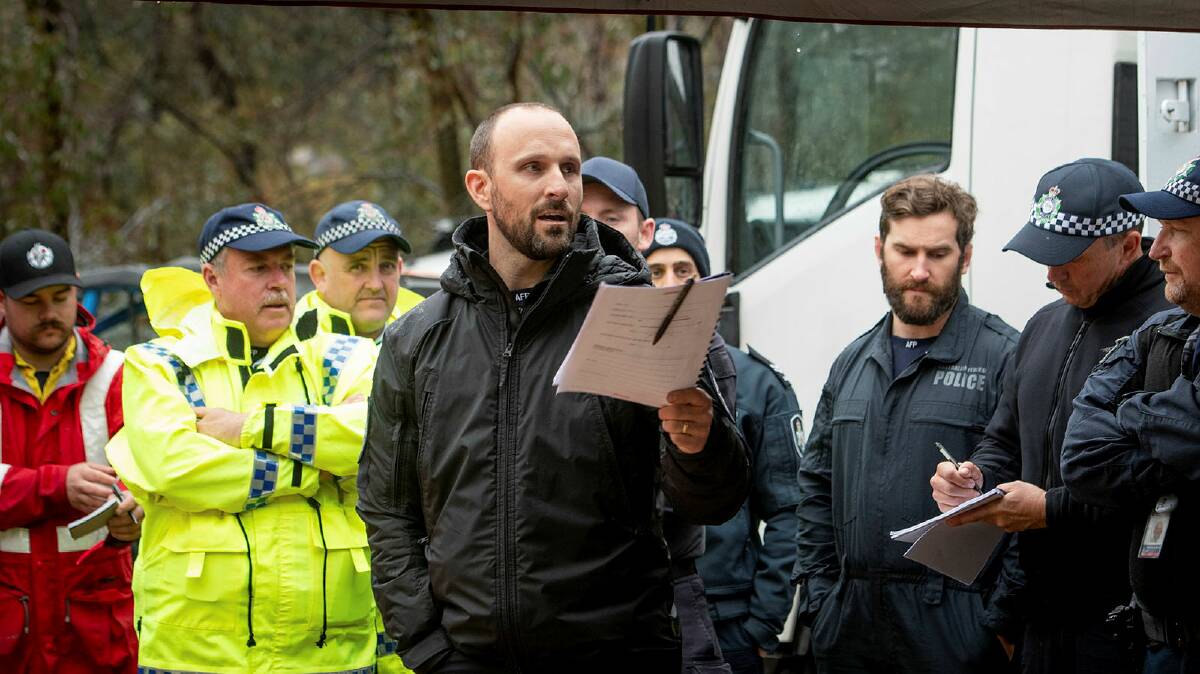 Leading senior constable Ashley Childs briefs emergency workers at police search and rescue training exercise at Namadgi National Park. Picture by Elesa Kurtz