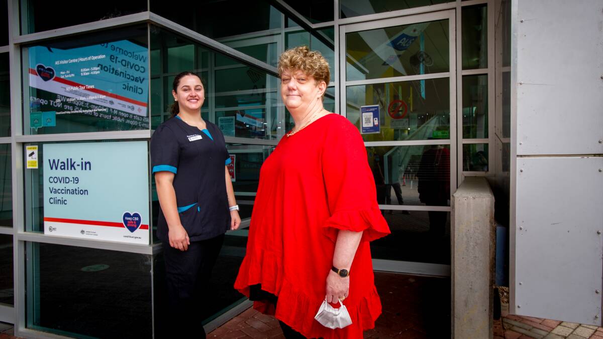 CHS nurse, Nikoletta Karagiannidis, who administered the first vaccination with Canberra Health Services' chief operating officer, Cathie ONeill, 12 months since the ACT began its COVID-19 vaccination rollout.